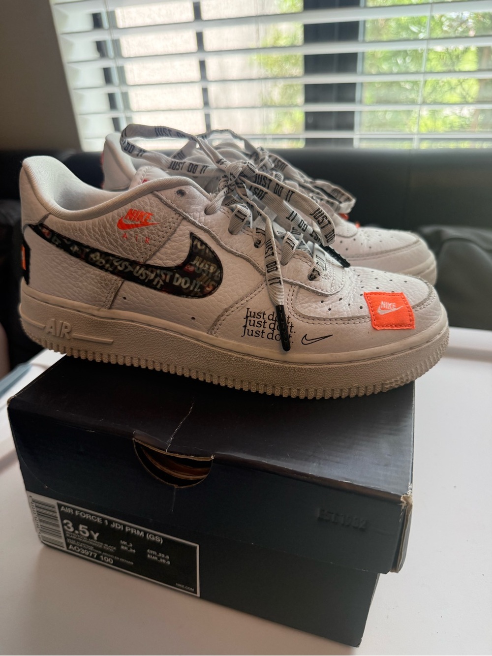 Nike White Air Force 1 Low with Black Swoosh and Orange Accents